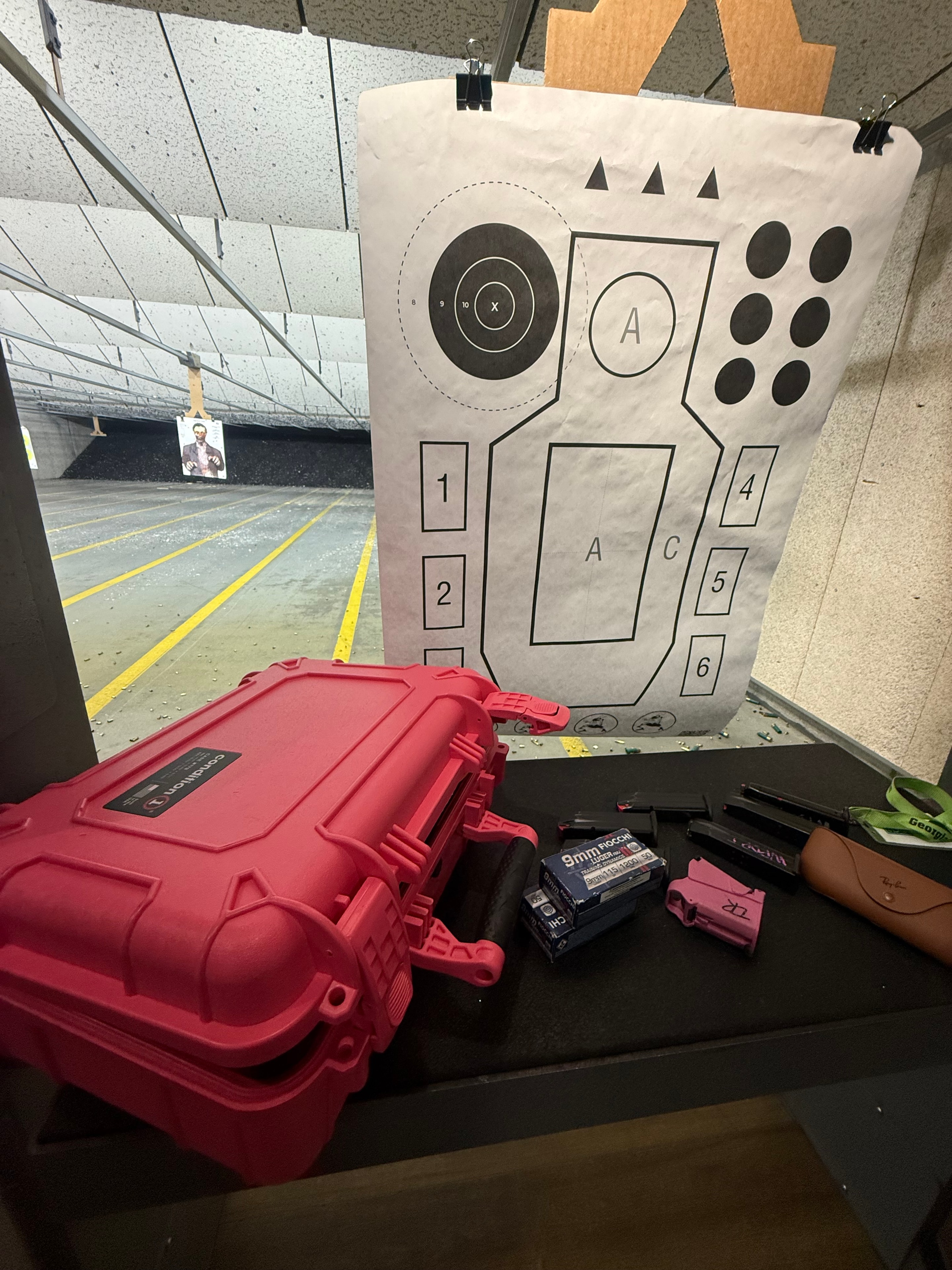 Shooting target and pink range case at an indoor range