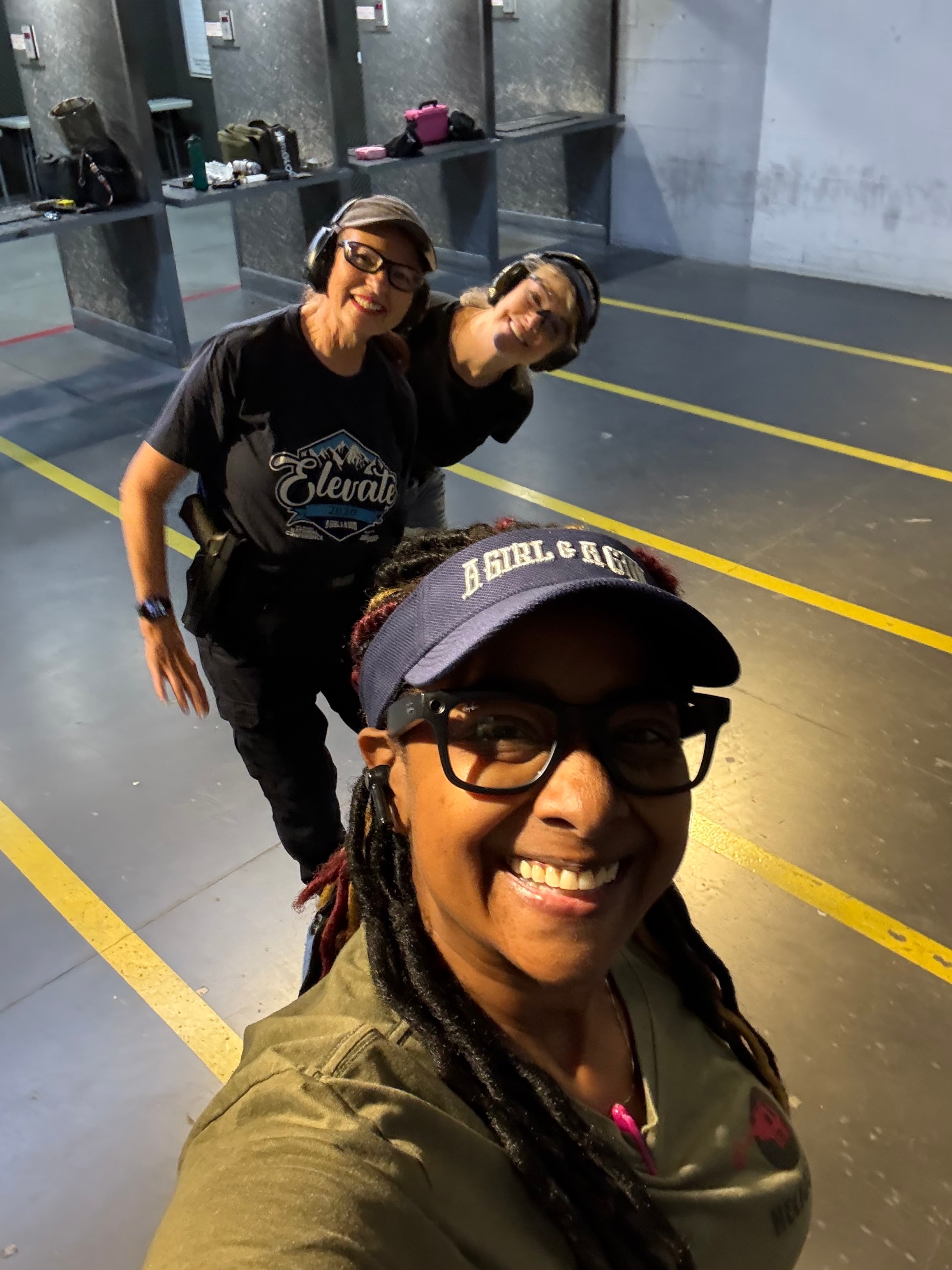 Three women at an indoor shooting range